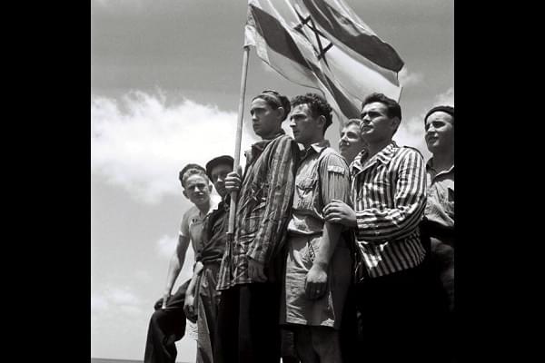 Jewish survivors stand on the deck of a refugee immigration ship at Haifa port, during the British Mandate of Palestine, in what would later become the state of Israel. (Zoltan Kluger/GPO via Getty Images)